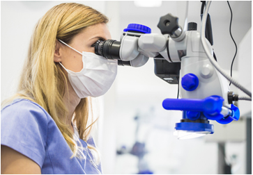 Doctor using a medical microscope